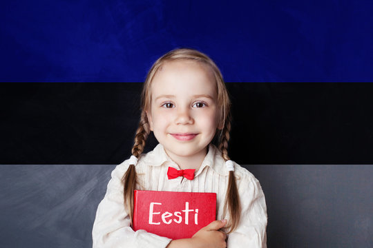 Estonian language concept with litte girl student with book against the Estonian flag background. Learn language