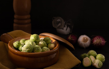 Organic raw Brussels sprouts on a kitchen table, selective lighting