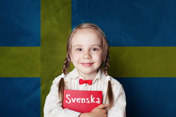 Swedish concept with little girl student with book against the Sweden flag background. Learn...