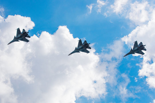 Three military fighter is in the sky with clouds