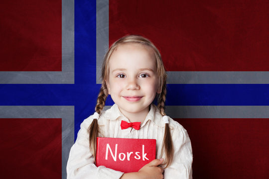 Norwegian concept with smiling kid student with book against the Norway flag background. Learn norwegian language