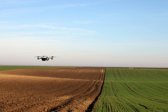 The drone is flying over the plowed field autumn season