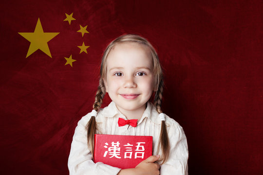 Learn chinese language. Smart child student on Chinese flag background