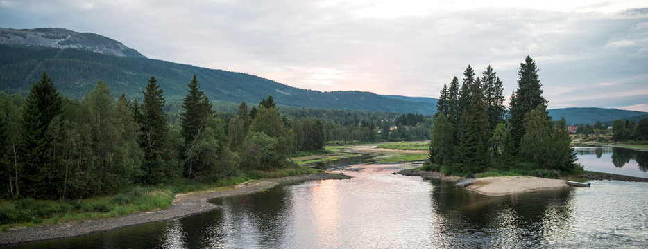Panoramic view of lake near forest and mountains in Trysil, Norway's largest ski resort