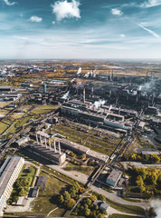 Concept of environmental pollution, drone view of smokestack pipe steel plant, aerial industrial panoramic landscape with blue sky and autumn vegetation, air emissions from manufacturing sector,Russia