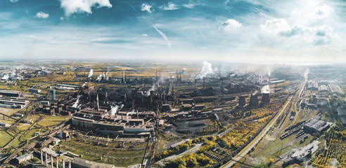 Concept of environmental pollution, drone view of smokestack pipe steel plant, aerial industrial panoramic landscape with blue sky and autumn vegetation, air emissions from manufacturing sector,Russia