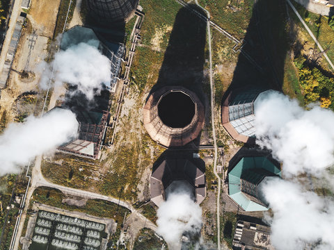 Concept of environmental pollution, aerial drone view of smokestack pipe steel plant, industrial panoramic landscape with autumn vegetation,mair emissions from the manufacturing sector, top down view