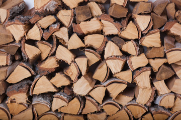 Preparation of firewood for the winter. Close up of the birch woodpile