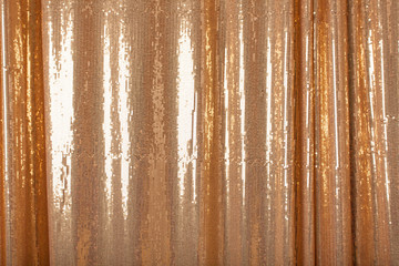 Background of golden bright sparkles on the fabric