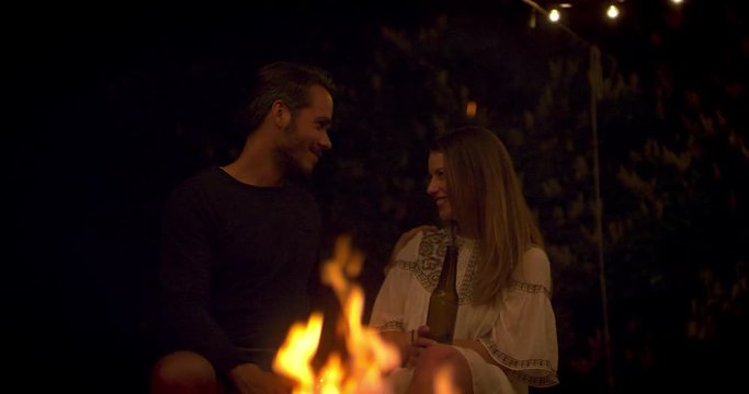 Couples having a romantic flirt at a fireplace 
