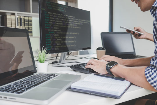 Programmers cooperating at Developing programming and website working in a software develop company office, writing codes and typing data code