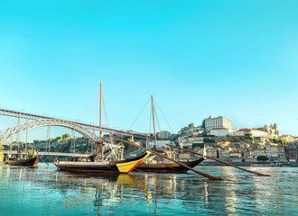 Fototapeta na wymiar Historical boats in Porto Portugal on the river. Beautiful view of the city