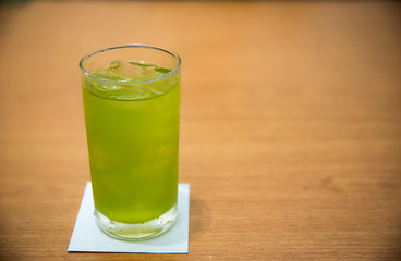 ice green tea in clear glass on the wood table. image for background, wallpaper and copy space