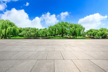 Empty city square floor and green woods scenery