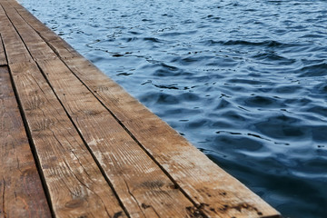 Wooden desk with blue sea. Texture. half wooden half water.Background