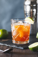 The alcoholic Surfer on Acid cocktail in a old-fashioned glass with a lime wedge.