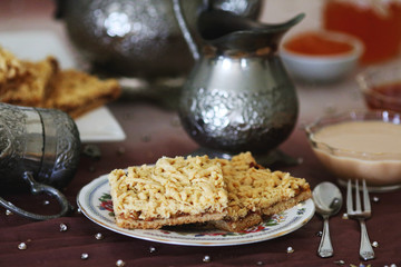 Grated pie served with coffee and jam