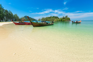 White sand beach and Long-tail boat at Kham-Tok Island (koh-kam-tok), The beautiful sea Ranong Province, Thailand.