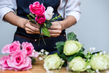 Arranging artificial flowers vest decoration at home, Young woman florist work making organizing diy artificial flower, craft and hand made concept