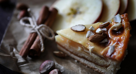 Pie with cinnamon and apples on a wooden table. Fresh pastry wit