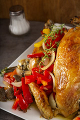 Baked whole chicken with fried vegetables