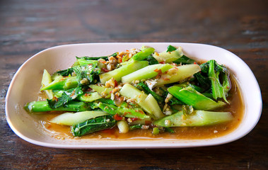 Stir-fried kaled with sun-dried salted fish, thai smelly local food. Pad Ka Na Pla Kem.  Fired kale with red chille 