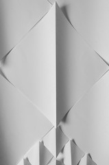 White paper folded into square and triangular shapes