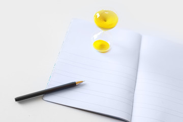 pen, notebook, sand watch 