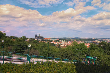 Fototapeta premium Prague, Czech Republic-AUGUST 21,2018: Landscape photo of Prague Castle with saint Vitus Cathedral View from Petrin Hill funicular tram station by summer sunny day