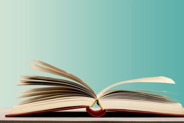 Open book on old wooden table.