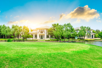 Green meadow and woods with apartment buildings scenery in summer
