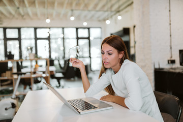 Businesswoman having video conference in bright co-working space.