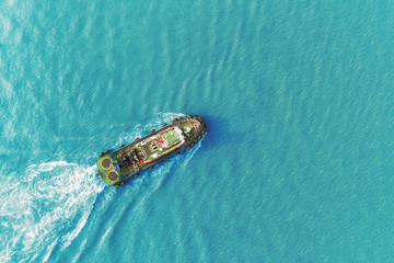 Tug boat driving in high speed for push ship container for transportation concept.