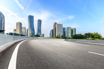 Fototapeta na wymiar Urban asphalt road and modern buildings in Hangzhou