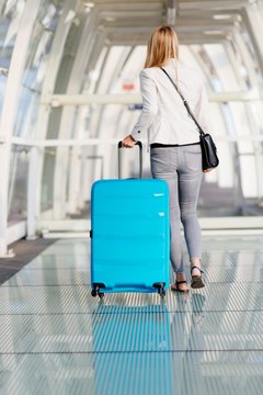 Woman with her baggage on airport terminal