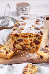 Traditional Christmas cake with fruits and nuts on white table