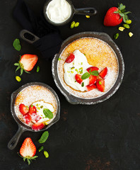 almond pie with cream and strawberries. View from above.