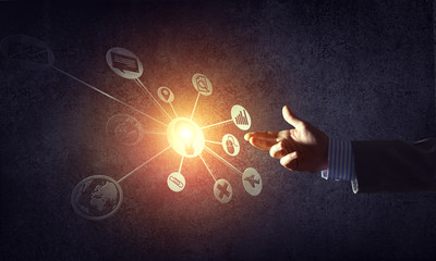 Close of businessman hand showing at user interface glowing on wall