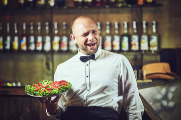 Waiters distribute plates with dishes at the celebration