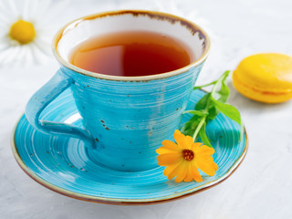 A beautiful cup of tea and a macarons.