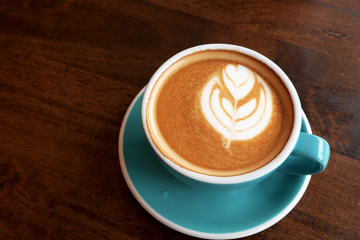 Hot latte on a wooden table