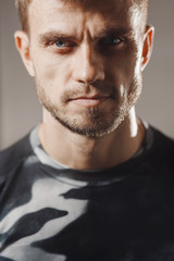 Fototapeta premium Portrait of handsome man sportswear in gym. Vertical photography.