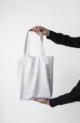 holding bag canvas fabric for mockup blank template isolated on gray background.