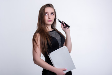 girl in glasses in a black dress with folders on a white background, office worker