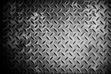 Steel texture from Manhole cover. Metallic background and wallpaper. Detail of Manhole cover pattern.Metal diamond plate pattern and background seamless.