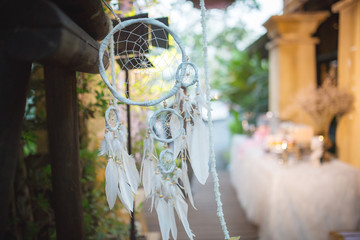 Dream catcher decorated in the wedding outdoor place. Sign of dream amulet. Symbol of charm