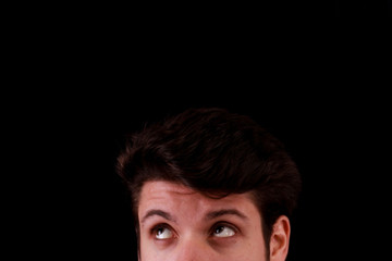 Fototapeta premium Young man thinking black background