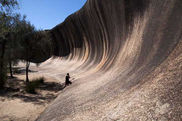 Hyden Australia,  person looking back along the natural feature called wave rock