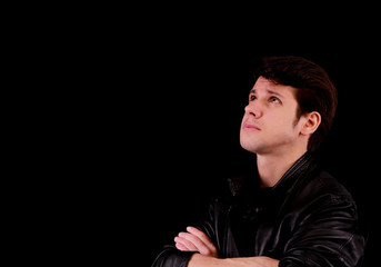 Obraz premium Portrait of an handsome up looking up. Isolated on black