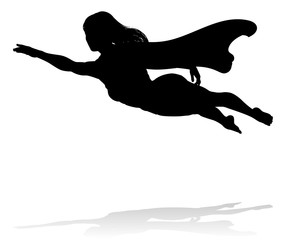 A woman caped superhero flying in silhouette © Christos Georghiou